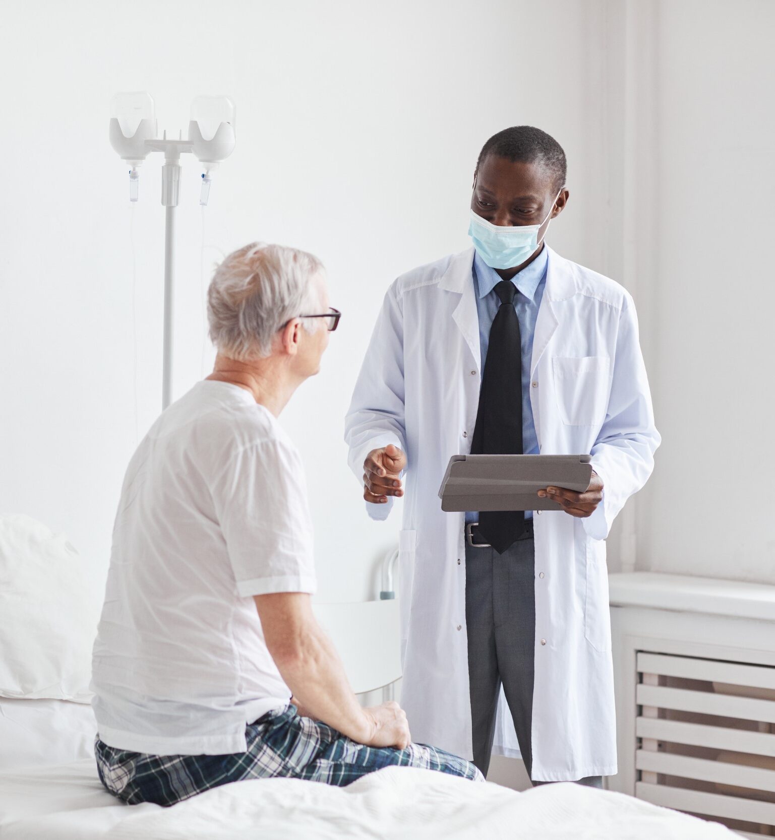 african-american-doctor-consulting-senior-man-in-h-2021-09-24-04-17-13-utc-Custom-e1644549956675.jpg