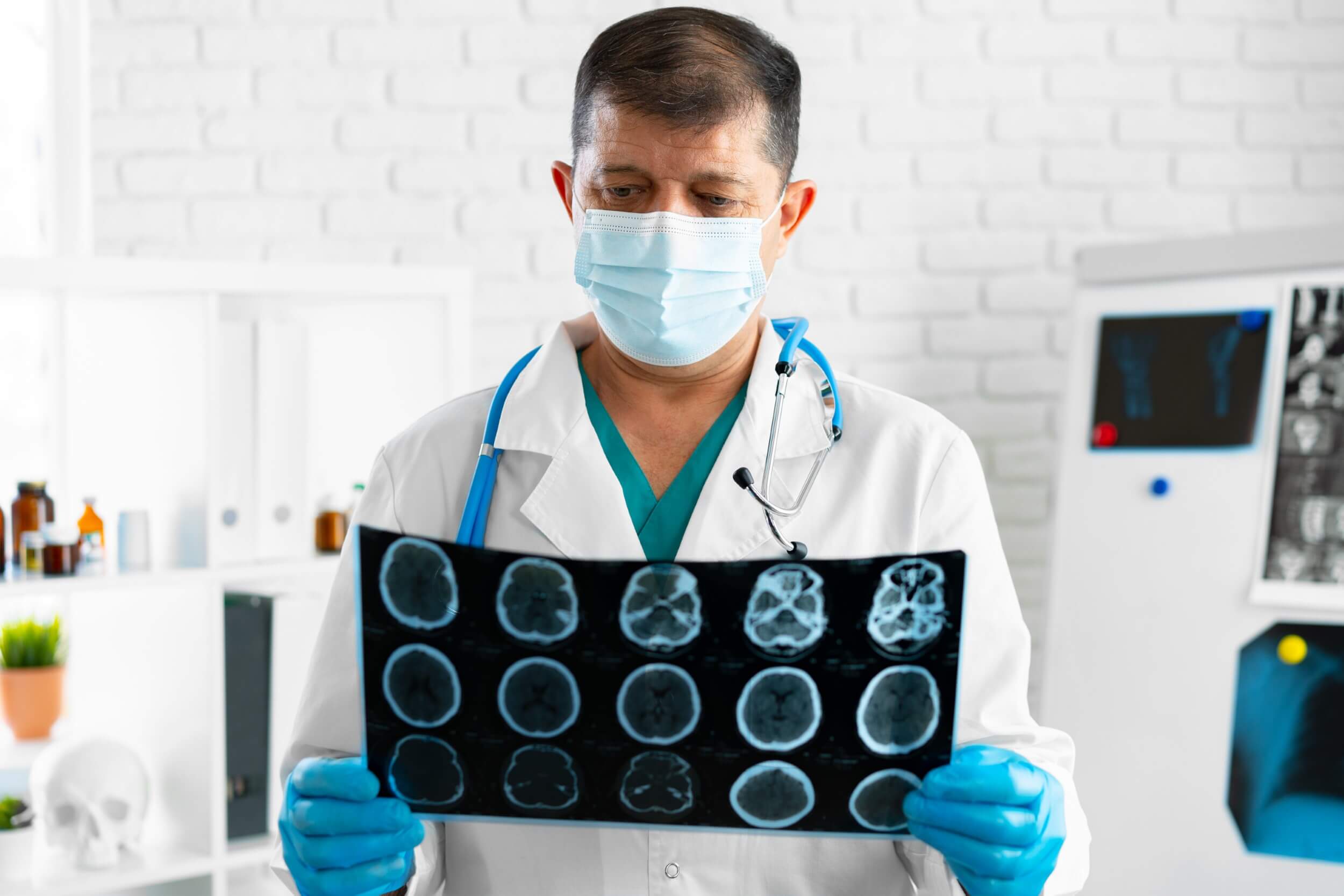 senior-man-doctor-in-mask-examines-head-mri-in-hos-2021-09-03-08-51-26-utc.jpg